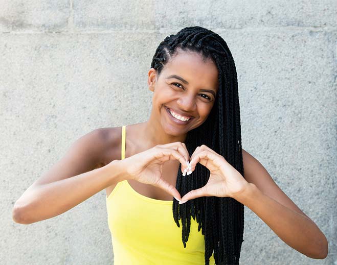 woman forming heart with hands